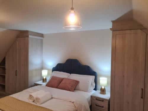 a bedroom with a large bed with a blue headboard at Sky's Haven in Sunningwell