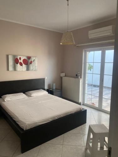 a bedroom with a bed and a view of the ocean at Chalkida Beautiful Home with Stunning Views in Chalkida