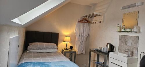 a small bedroom with a bed and a window at Inverour Guest House in Spean Bridge