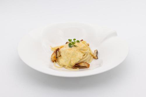 a plate of food with a cooked chicken with sauce at La Darsena Boutique Hotel & Restaurant in Tremezzo