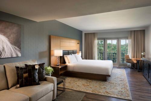 a hotel room with a bed and a couch at Hyatt Regency Hill Country Resort & Spa in San Antonio