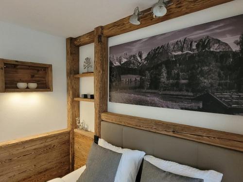 a bedroom with a large painting above a bed at Tirol Chalet Brixen in Brixen im Thale
