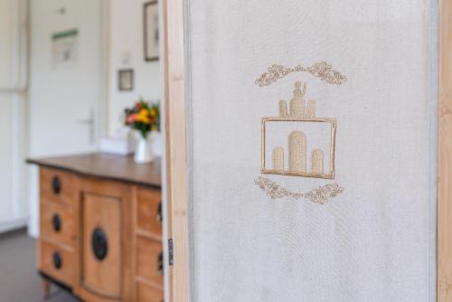 a door with a picture of a kitchen with a table at Hotel-Pension am Siegestor in Munich