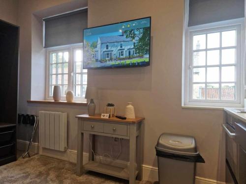 a living room with a tv on the wall at The County in Newton Aycliffe