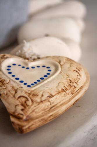 a wooden heart shaped object sitting on a table at Chateau de Marine Boutique Hotel in Struisbaai