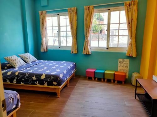a room with two beds and two windows at ELLIE HOUSE in Xiaoliuqiu