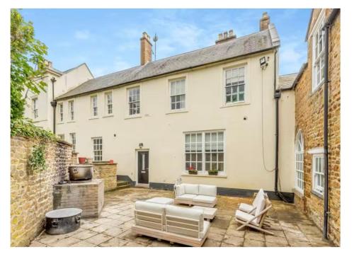 a large white house with a patio in front of it at The Annexe at Moulton Grange in Northampton