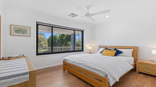 Ένα ή περισσότερα κρεβάτια σε δωμάτιο στο Frangipani House