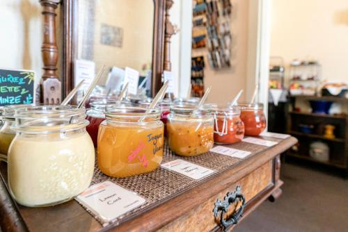 a counter with many jars of jam on it at Hotel-Pension am Siegestor in Munich