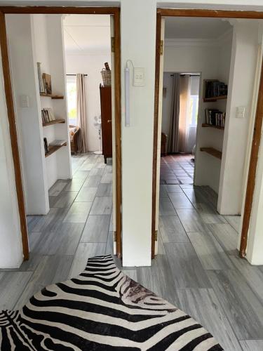 a zebra rug on the floor of a hallway at Welbedacht Game & Nature Reserve in Tulbagh