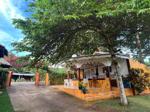 a small building with a tree in front of it at E&N Paradise Island Resort in Siquijor