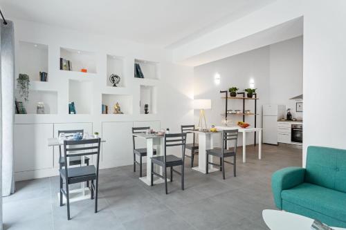 a kitchen and living room with a table and chairs at Double D House in Olbia