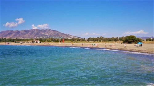 a beach with a bunch of people on the beach at La Baraka de Guadalmar B&B Aeropuerto in Málaga