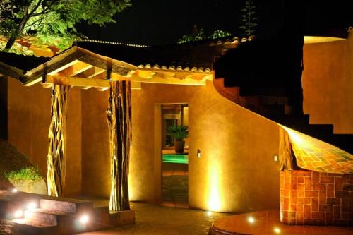 a house with a stairway leading to a door with lights at Hacienda Ucazanaztacua in Pátzcuaro