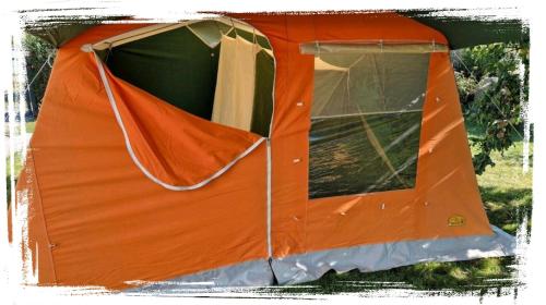 an orange tent is sitting in the grass at DDR Kult Steilwandzelt POUCH direkt am Strand in Dranske