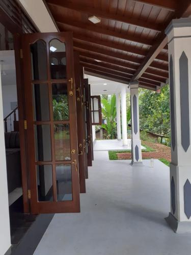 an open door to a house with a porch at VILLA GREEN VILLAGE in Kamburugamuwa