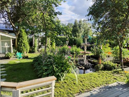 a garden with a pond and a fence at Kaliininkuja in Lapua