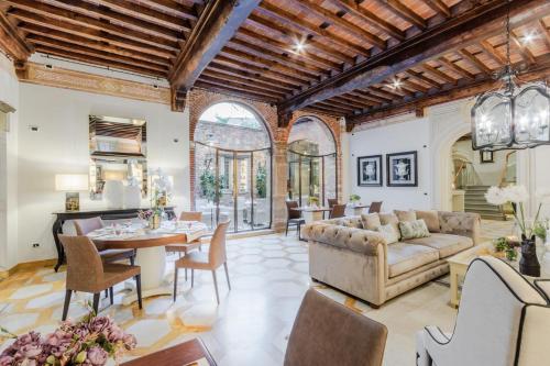 a living room with a couch and a table at Lucca Heritage Retreat in Lucca