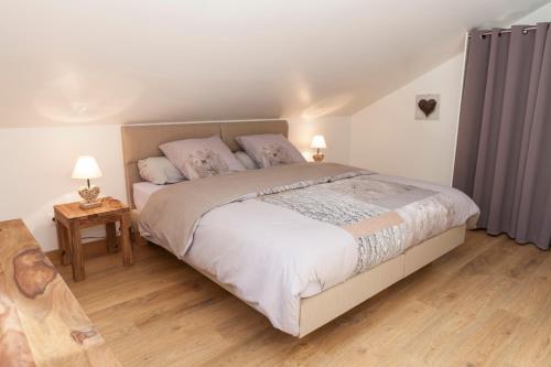 a bedroom with a large bed with two pillows at Les Cabanes de Fontfroide in Saint-Antoine