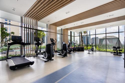 a gym with treadmills and cardio equipment in a building at METROPOLE -Central Saigon Riverside -Free POOL-GYM-SAUNA Room-YOGA Room in Ho Chi Minh City