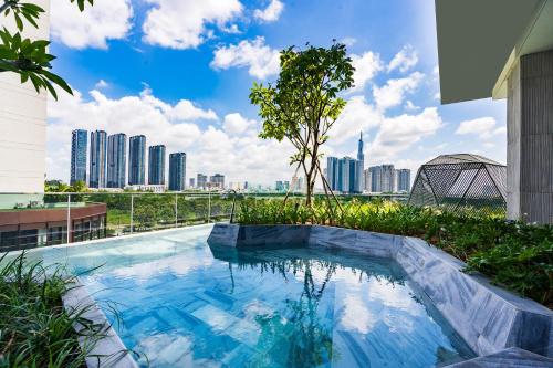 a swimming pool with a city skyline in the background at METROPOLE -Central Saigon Riverside -Free POOL-GYM-SAUNA Room-YOGA Room in Ho Chi Minh City