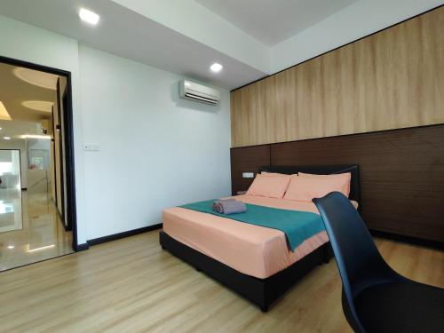 a bedroom with a bed and a chair in it at Sibu Q2 Homestay -1st Floor, 4 Rooms 5 Beds in Sibu