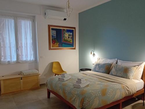 een slaapkamer met een bed en een stoel erin bij Casa L'agrumeto in Ventimiglia