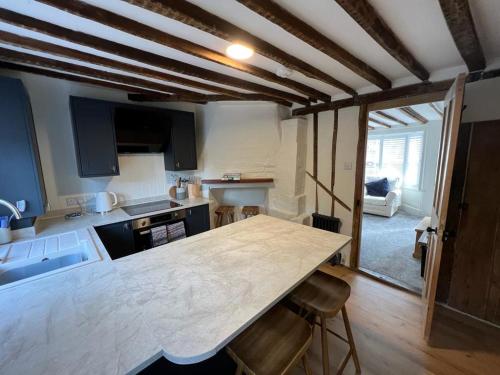 a kitchen with a large wooden table in a room at The Cottage, 13 Golden Sq. in Kent