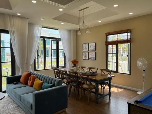 a living room with a couch and a table at KB Villas in Bình Sum