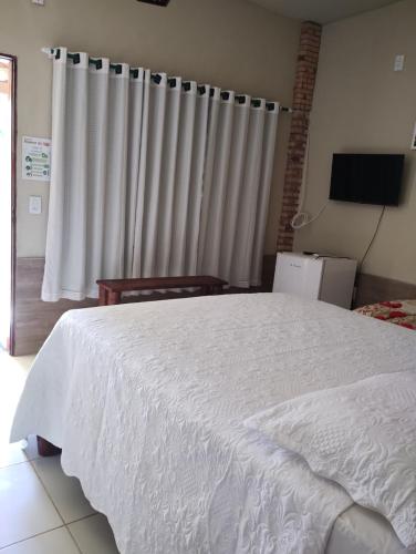 Una cama o camas en una habitación de Nascer do Sol Kitesurf House