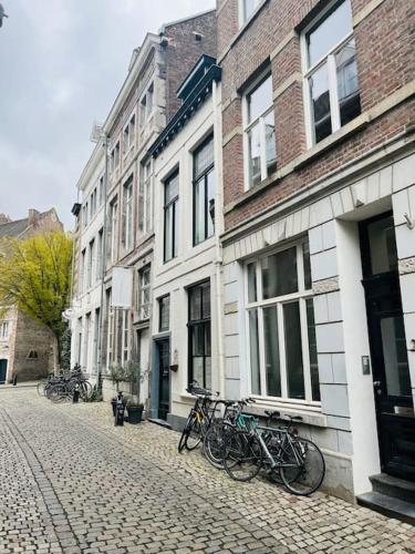 a group of bikes parked on the side of a street at Monumentale stadswoning in hartje binnenstad in Maastricht