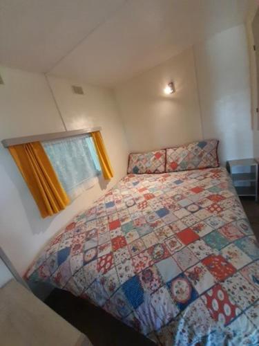 une chambre avec un lit avec une couette dessus dans l'établissement Bellevues Glamping and Camping, à Mérignac