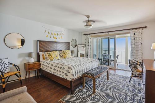 a bedroom with a bed and a living room at Arena De Madeira 502- Premier in St Pete Beach