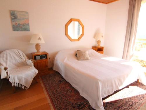 a bedroom with a white bed and a mirror at Appartement Huez, 3 pièces, 6 personnes - FR-1-405-69 in L'Alpe-d'Huez