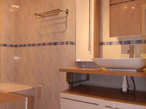 a bathroom with a white sink and a shower at Appartement Huez, 3 pièces, 6 personnes - FR-1-405-69 in L'Alpe-d'Huez