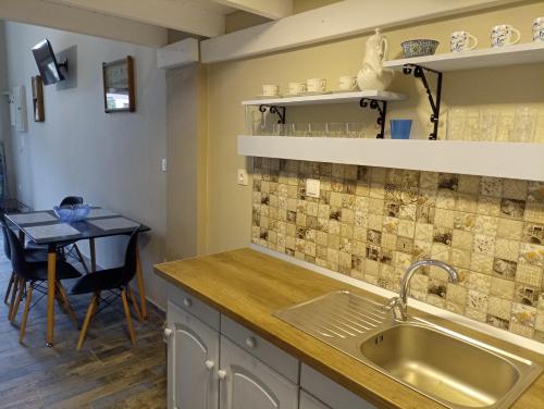 a kitchen with a sink and a table at Xristos apartment and maisonettes in Sykia Chalkidikis