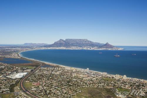 an aerial view of a city and the ocean at Peach on Beach Boutique Guesthouse in Bloubergstrand
