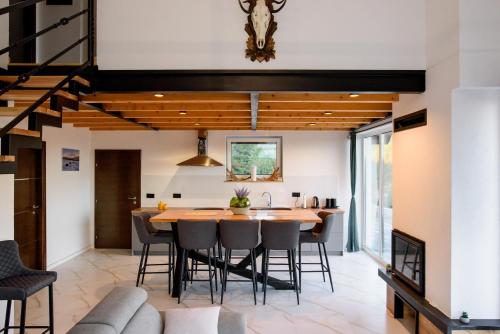 an open kitchen and dining room with a wooden table and chairs at Strane in Tomislavgrad