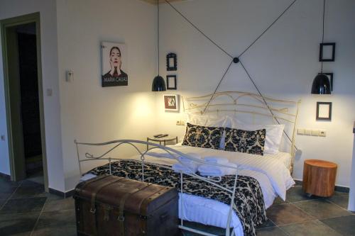 a bedroom with a large bed with a metal frame at Oikies Art Rooms in Ángistron