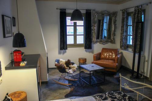 a living room with a couch and a chair at Oikies Art Rooms in Ángistron