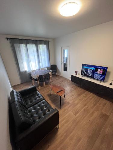 un salon avec un canapé et une table dans l'établissement Commerce à proximité et 10 minute de la gare, à Noisy-le-Sec