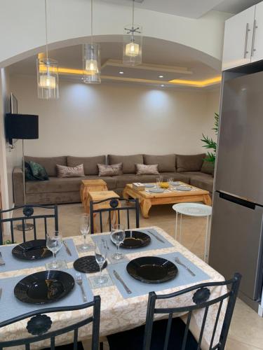 une cuisine et un salon avec une table et des chaises dans l'établissement Appartement Yassine, à Essaouira