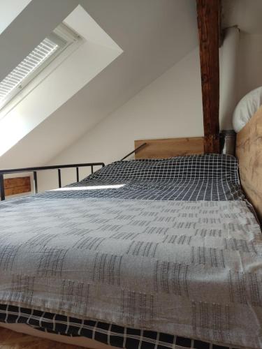 a bedroom with a bed in a room at Potkrovlje u centru in Sarajevo