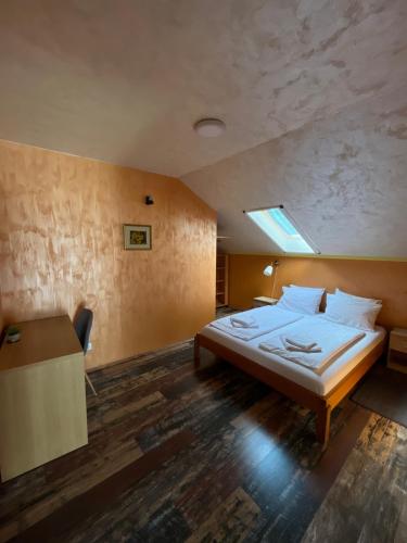 a bedroom with a bed and a desk in it at Apartment No10 in Golubac