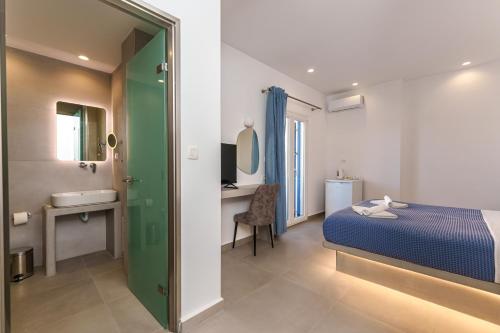 a hotel room with a bed and a bathroom at Anna's in Karterados