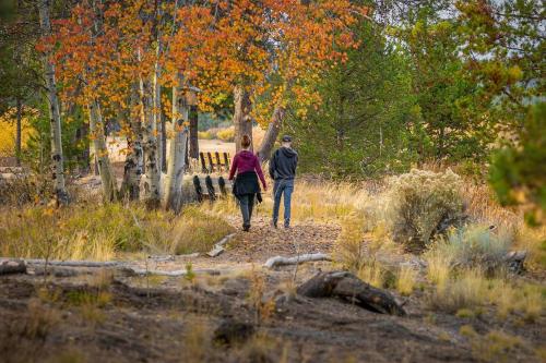 a man and a woman walking down a path at Towhee - Unit 5 in Sunriver