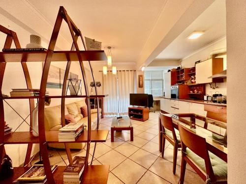 a kitchen and a living room with a couch and a table at Atlantic Bay in Costa da Caparica