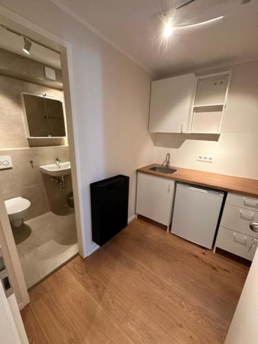 a small kitchen with a sink and a toilet at ELBI Apartment in Frankfurt/Main