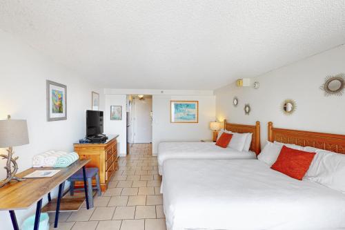 a hotel room with two beds and a desk at Island Colony 4218 in Honolulu