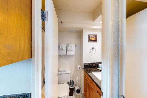 a bathroom with a toilet and a sink at Island Colony 3715 in Honolulu